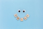 a smiley face made out of scrabble letters