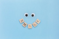 a smiley face made out of scrabble letters