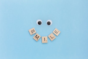 a smiley face made out of scrabble letters