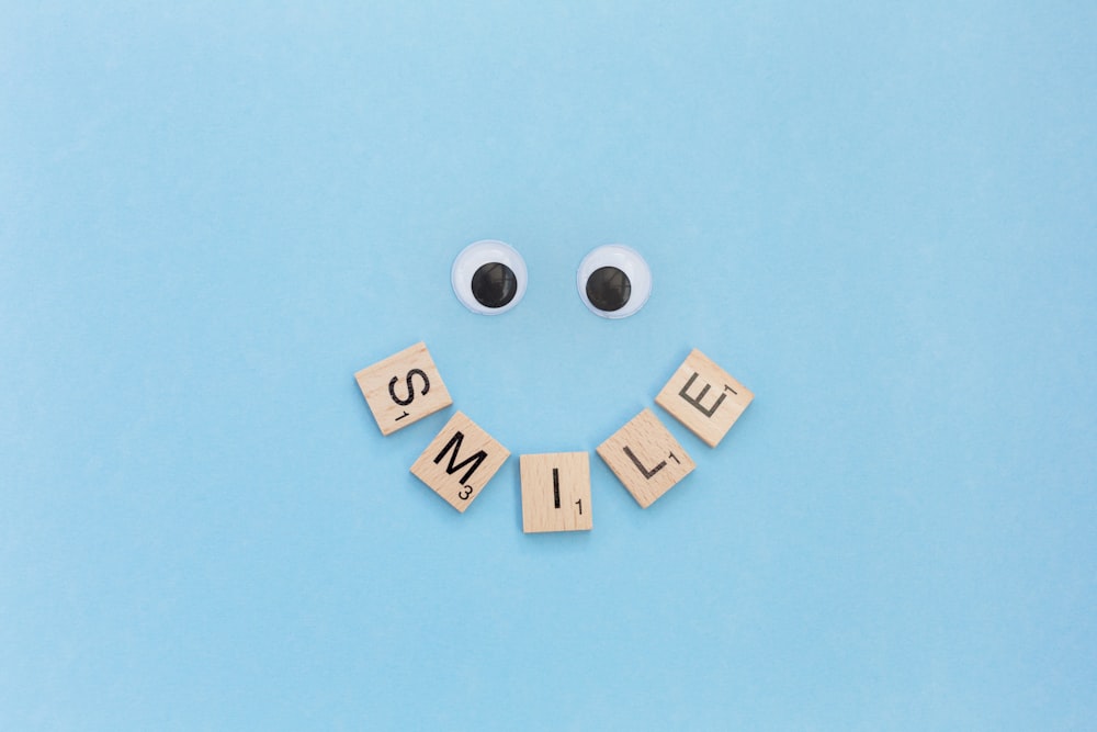 a smiley face made out of scrabble letters