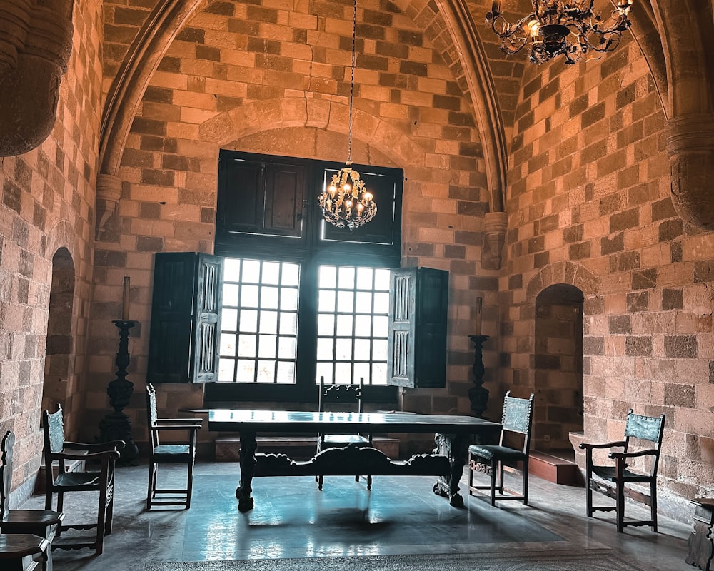 a room with a chandelier and a table in it