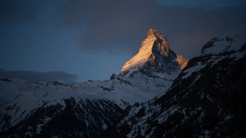 First light catching the snow-covered Matterhorn on a clear morning