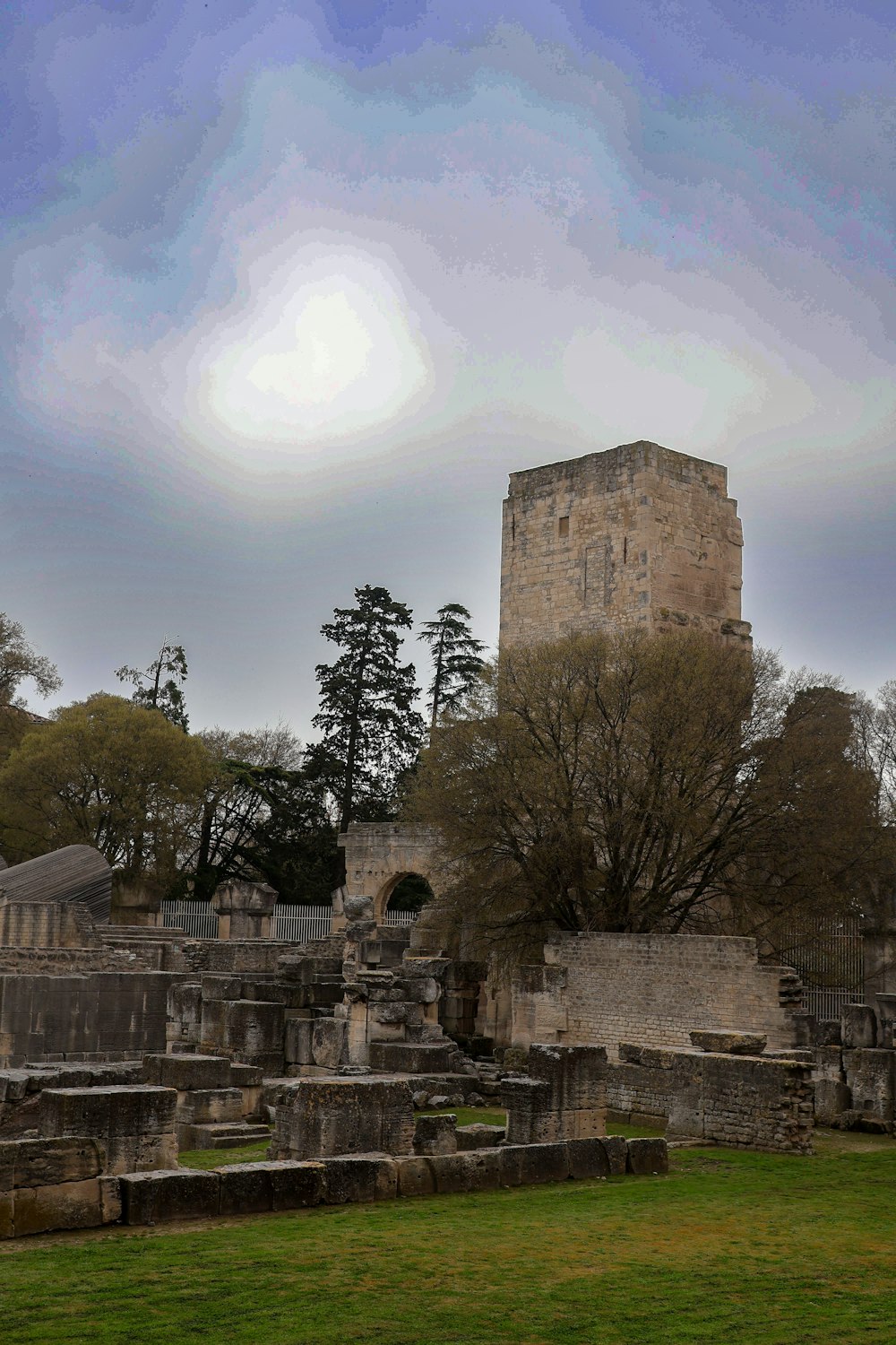 a very tall tower towering over a cemetery