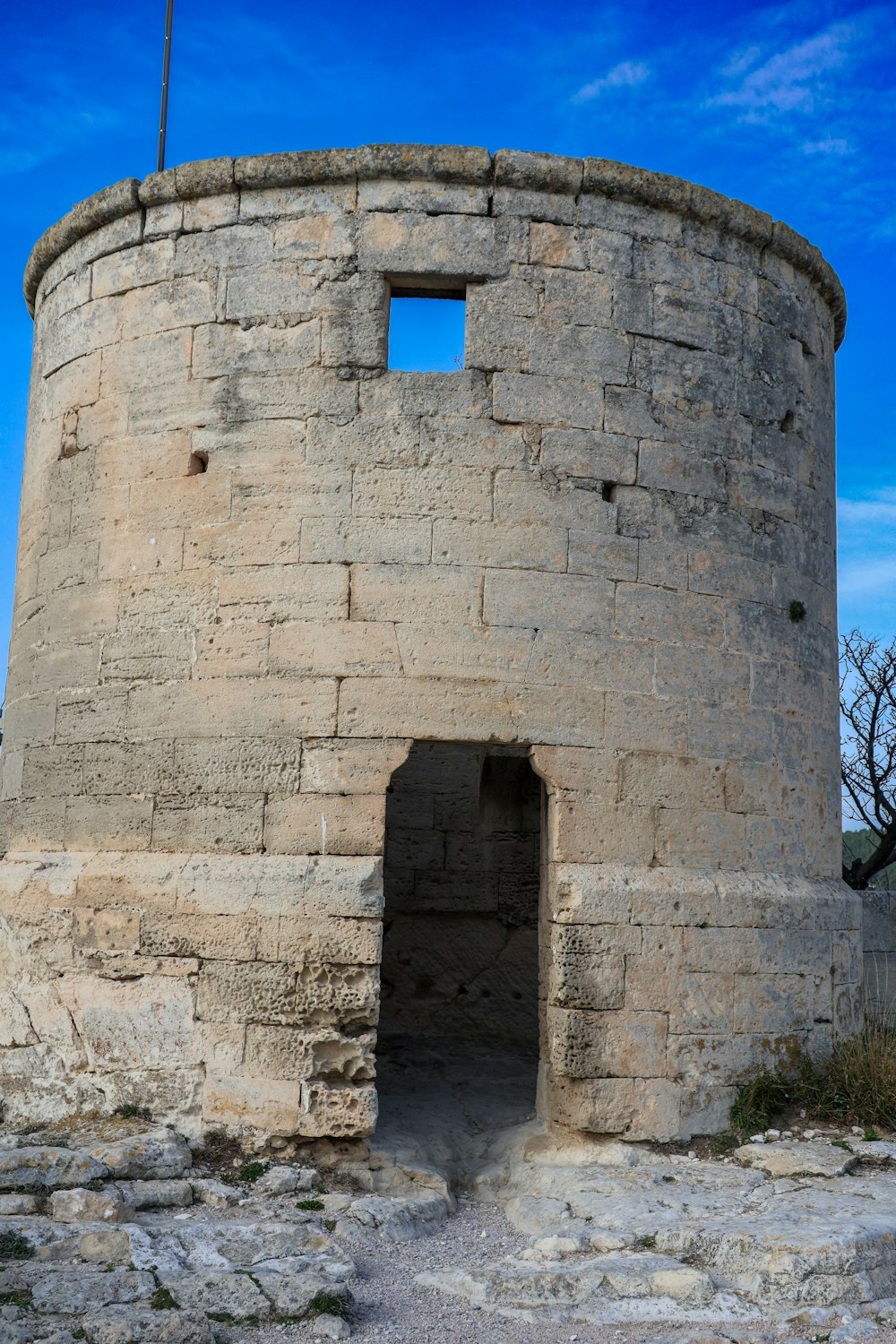 a stone tower with a flag on top of it