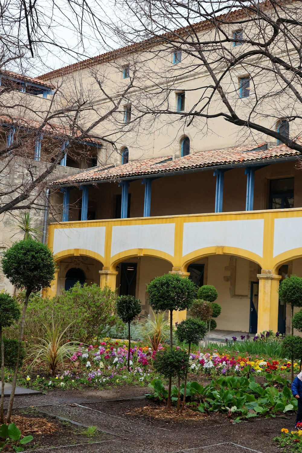 a woman sitting on a bench in front of a building