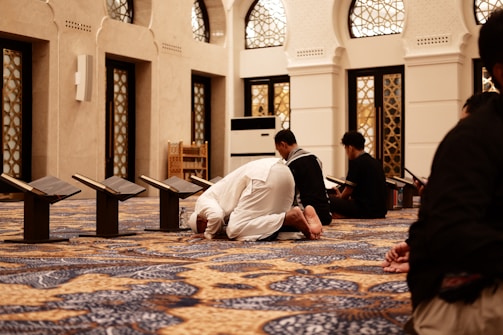 a group of men sitting on the floor of a building