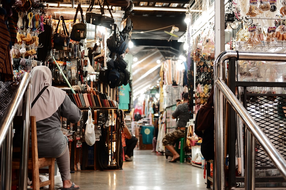 a woman is walking up a set of stairs in a store