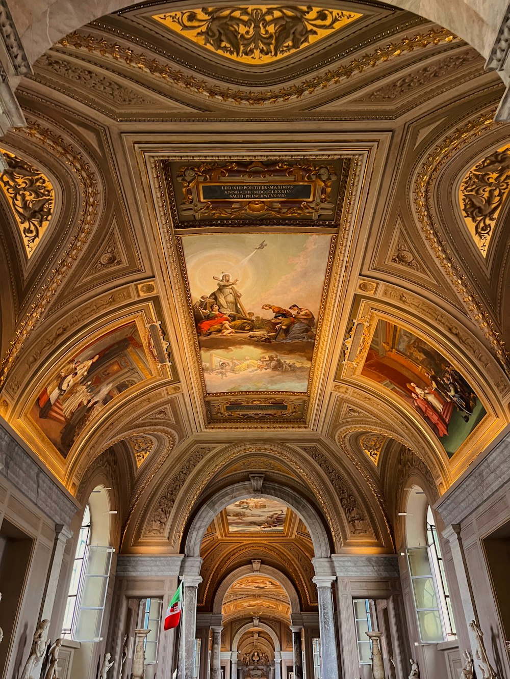 the ceiling of a building with a painting on it