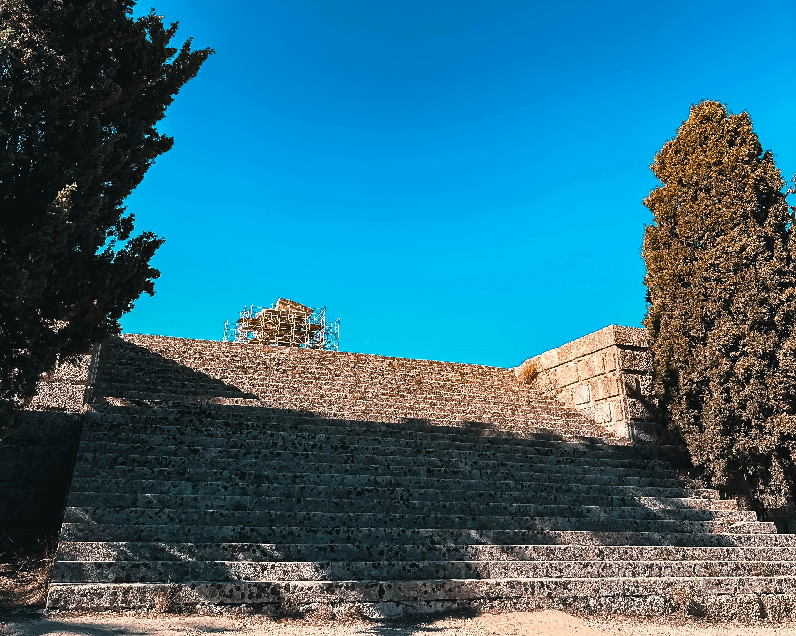a stone staircase with a scaffolding on top of it