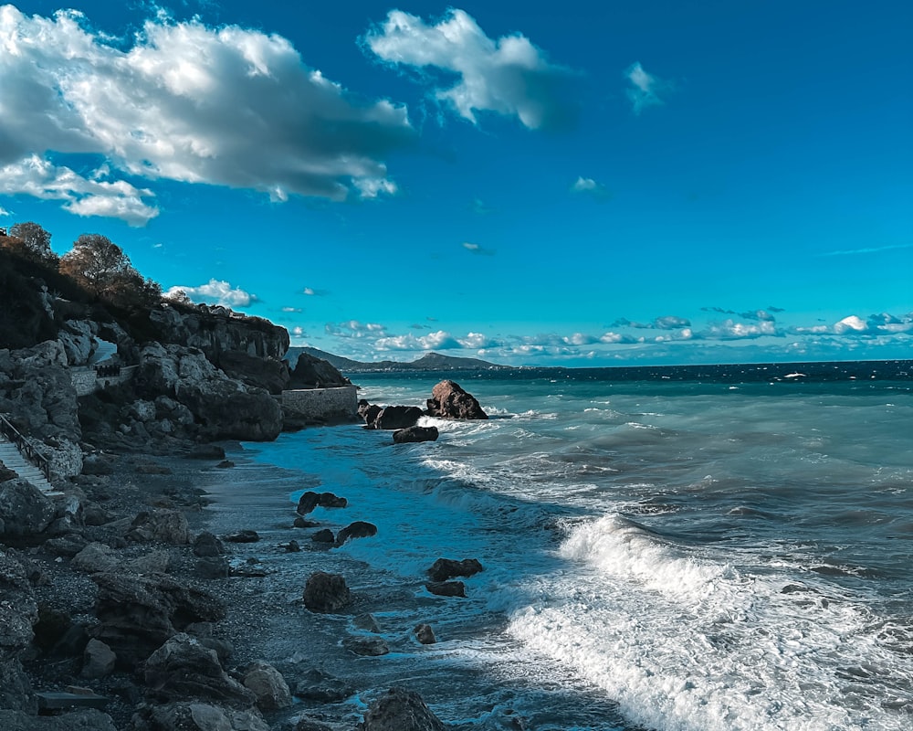 a view of the ocean from a rocky shore