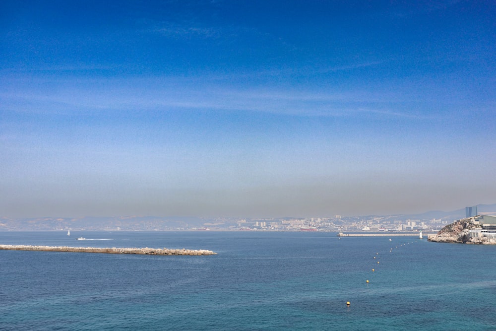 a large body of water with a city in the background