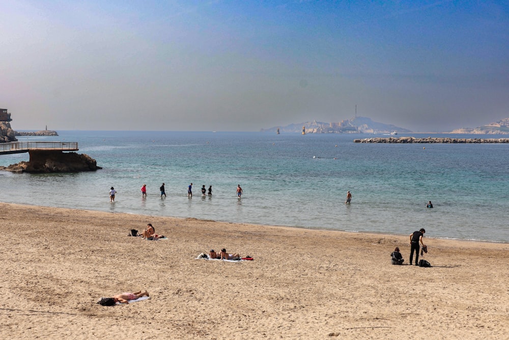 a group of people on a beach near the ocean