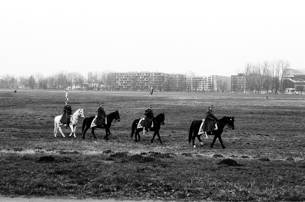 a group of people riding on the backs of horses