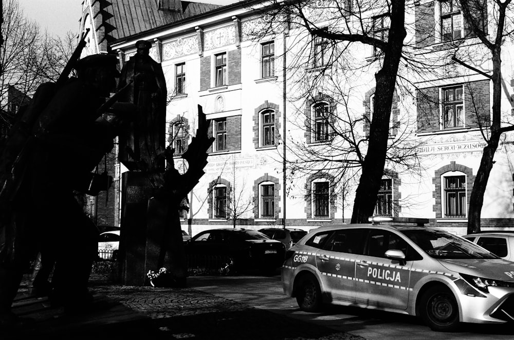 a police car parked in front of a building