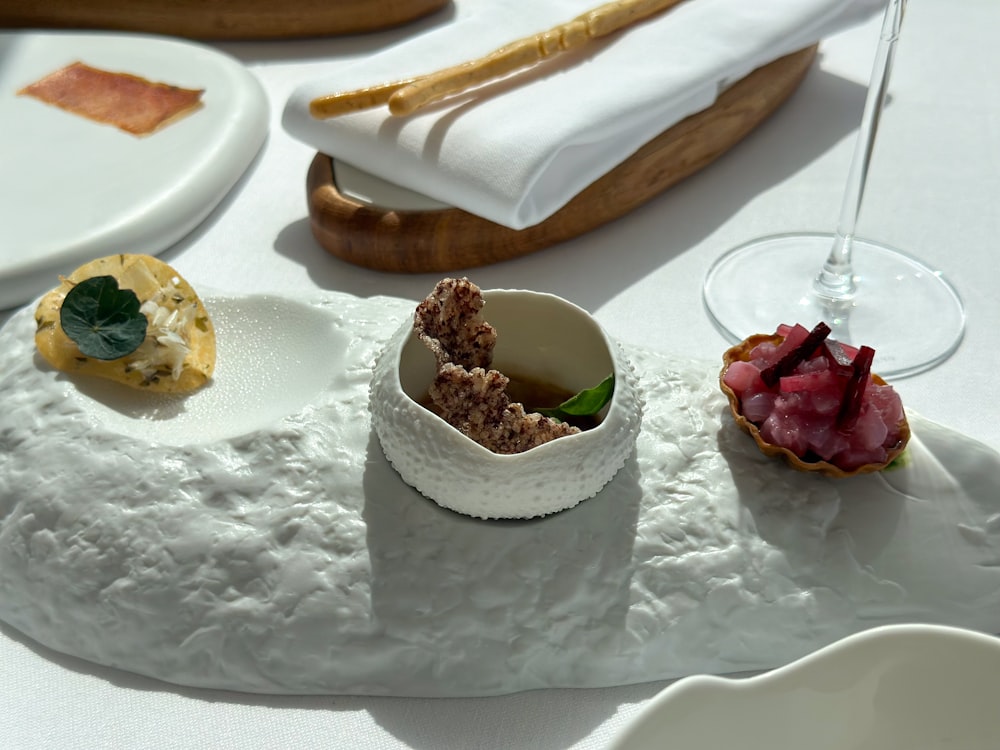 a table topped with plates and bowls filled with food