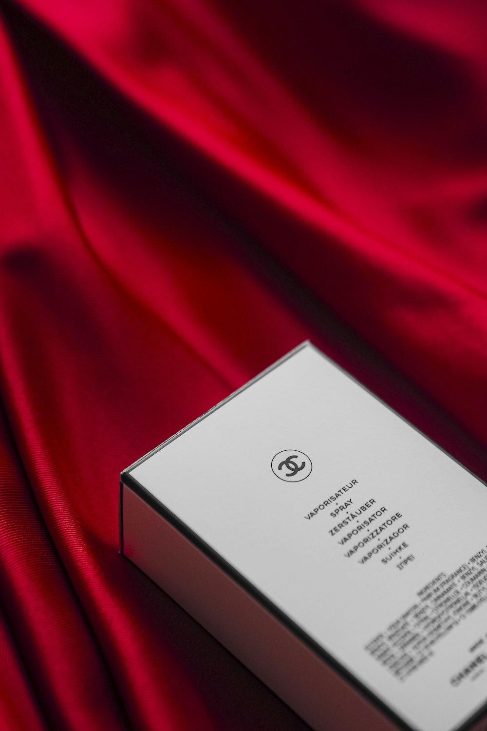 a white box sitting on top of a red cloth