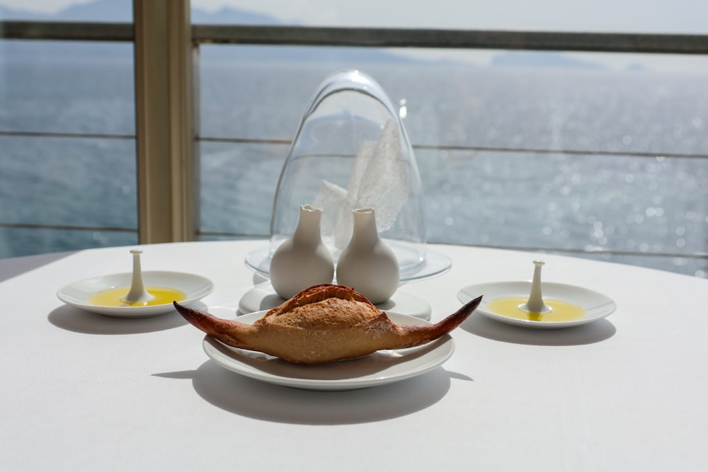 a white table topped with plates of food