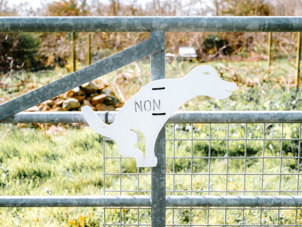 a metal fence with a sign on it that says non