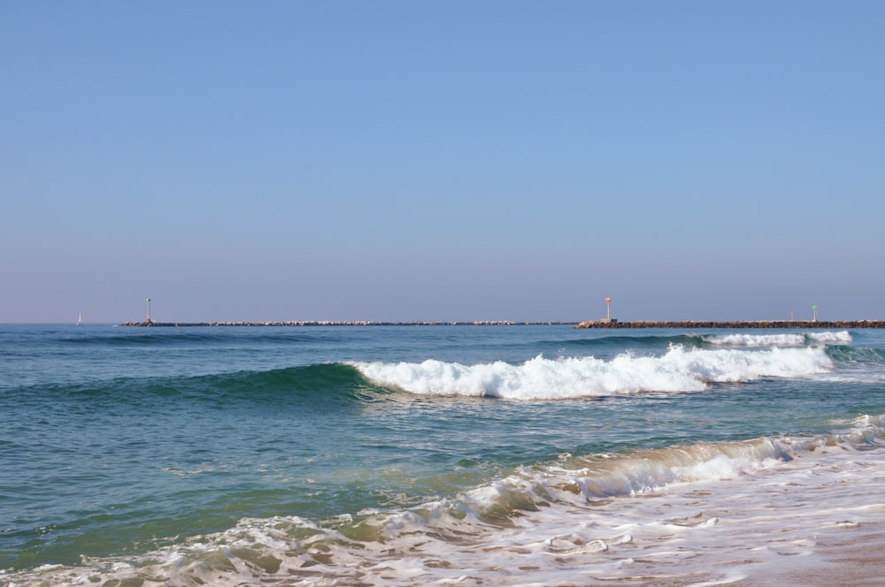 a large body of water with waves coming in to shore