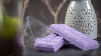 a couple of purple chocolates sitting on top of a table