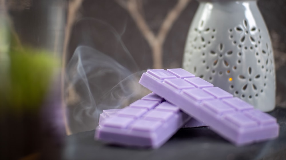 a couple of purple chocolates sitting on top of a table