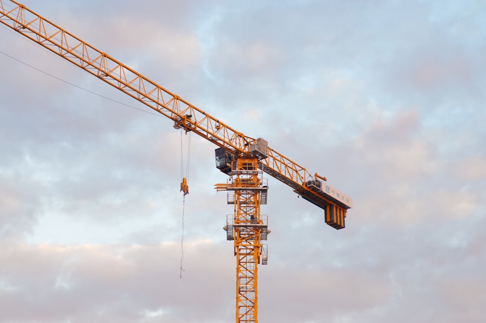 a yellow crane is on a cloudy day