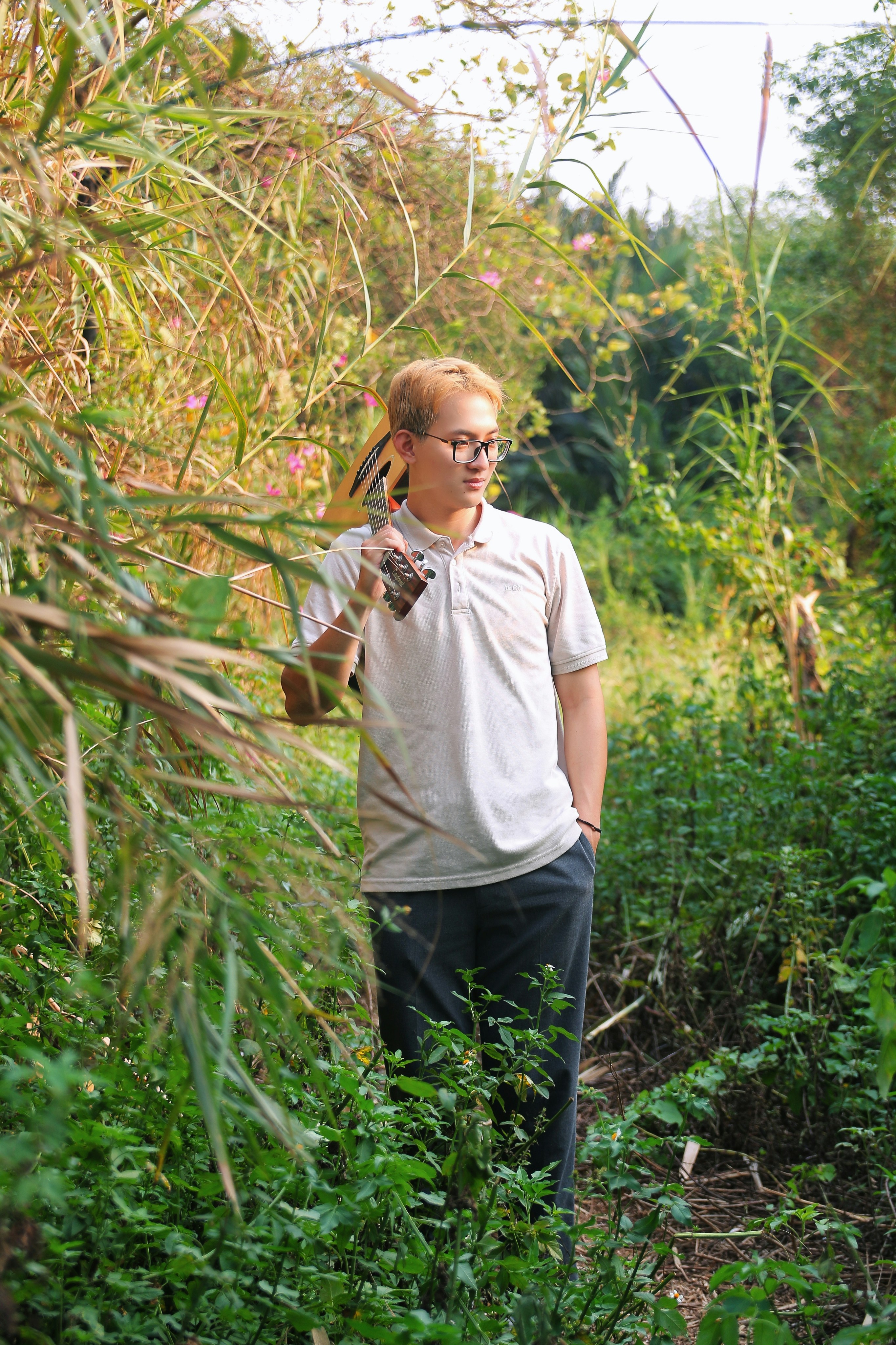 a man standing in a field with a bird on his shoulder
