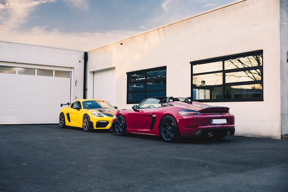two sports cars parked in front of a building