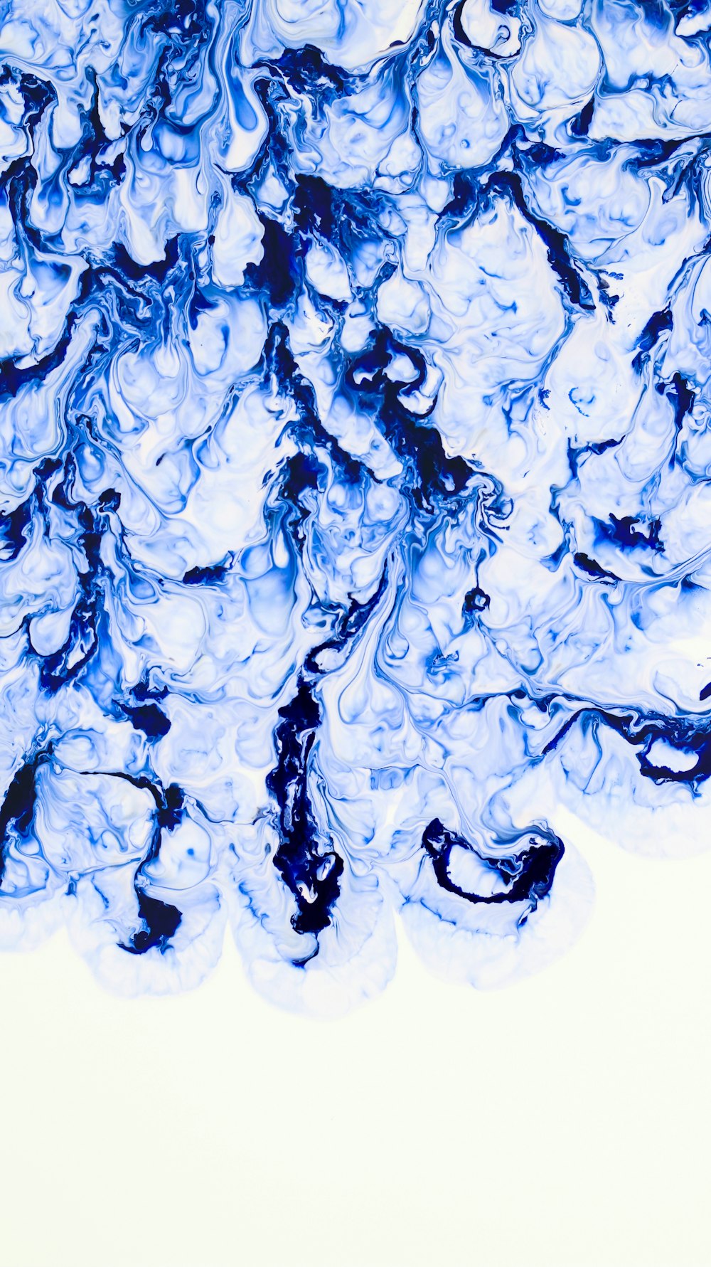 a close up of a blue substance on a white background