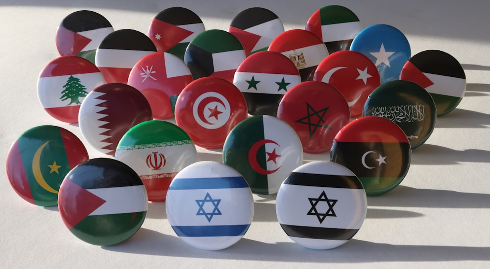 a bunch of different colored balls with flags on them