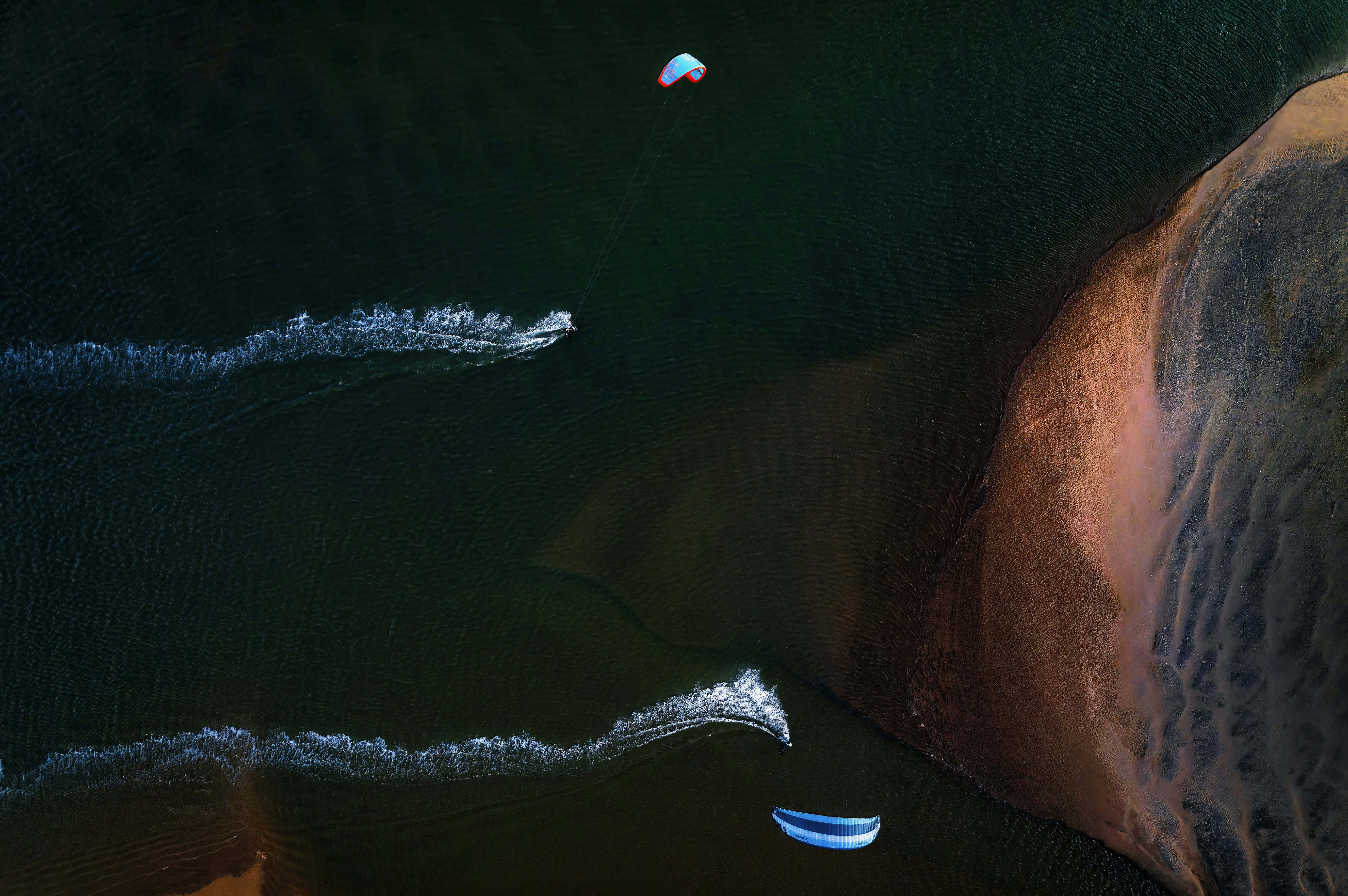 a couple of boats floating on top of a body of water