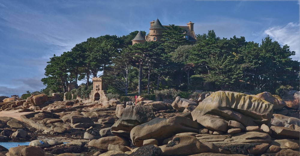 a castle sits on top of a rocky shore
