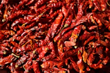 a pile of red peppers sitting on top of a table