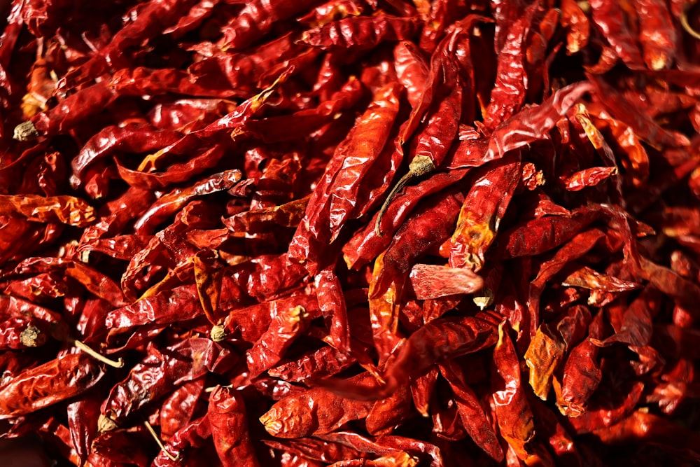 a pile of red peppers sitting on top of a table