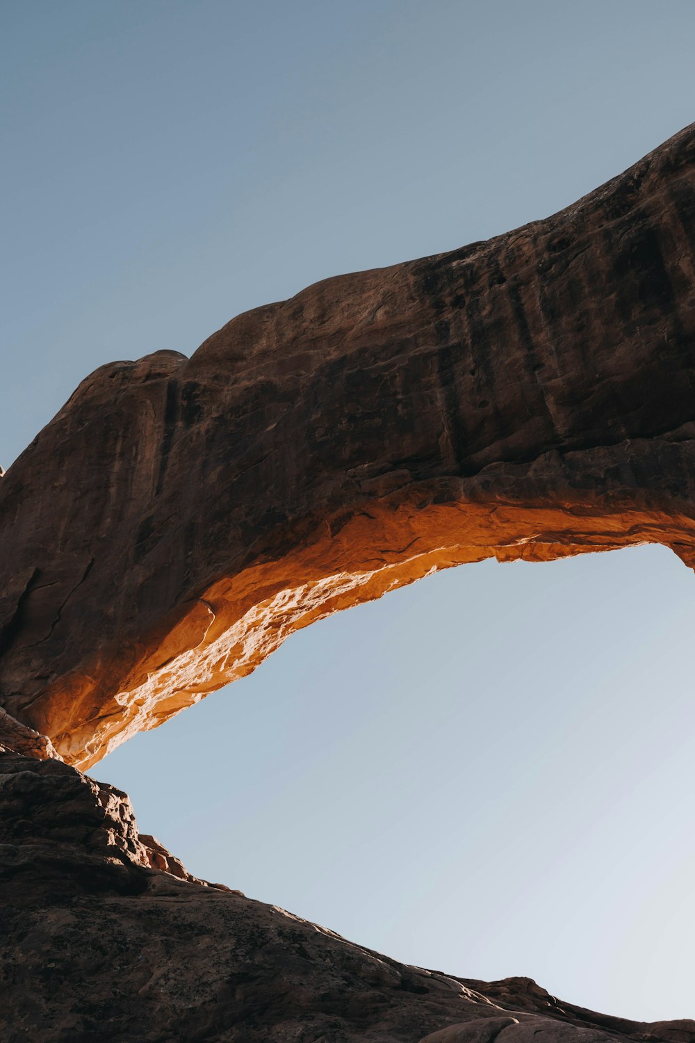 a man standing on top of a large rock formation