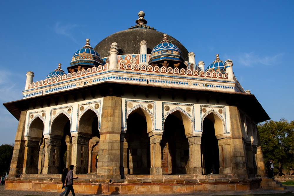 a man walking in front of a large building