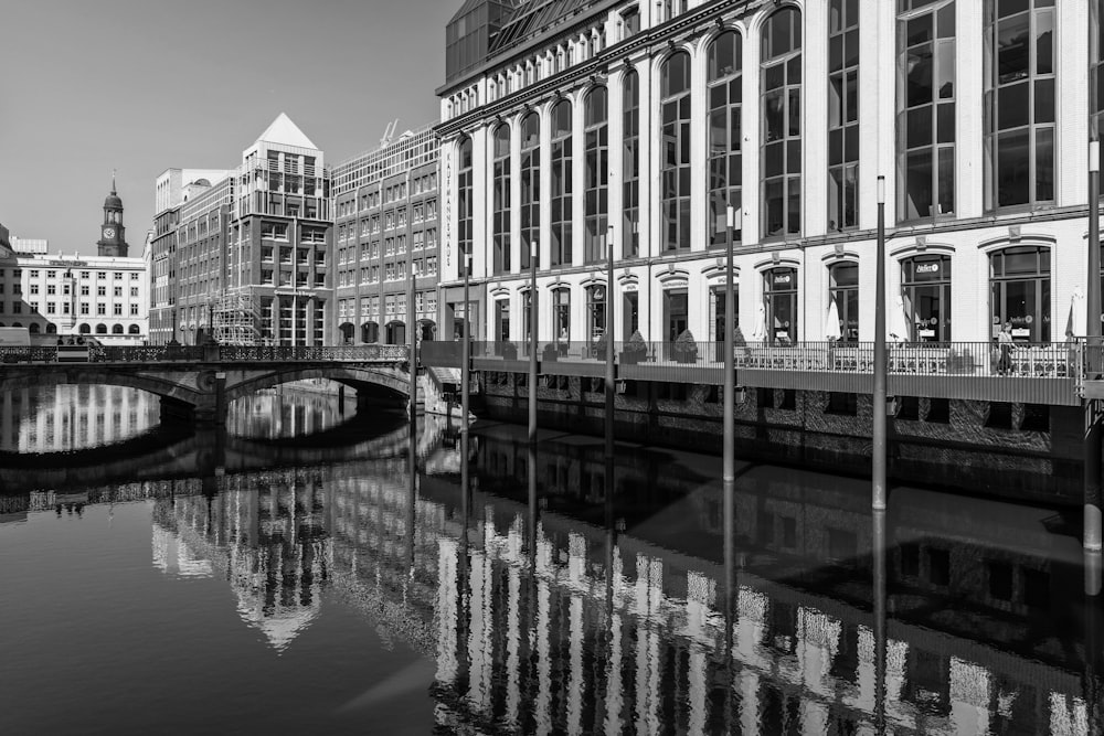 a black and white photo of a bridge and buildings