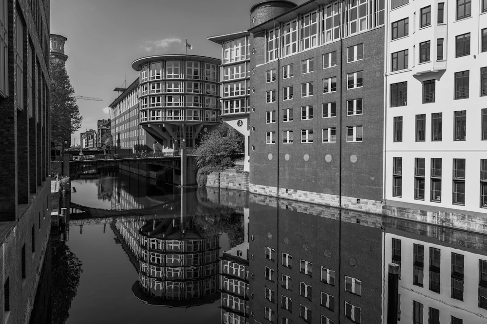 a black and white photo of buildings and a bridge