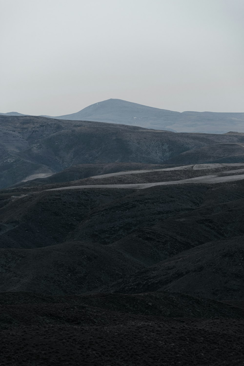 a view of a mountain range with hills in the distance