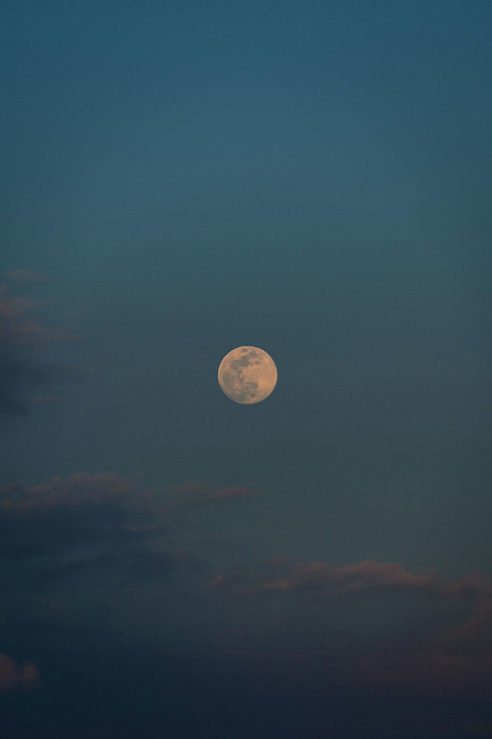 a full moon in the sky with clouds