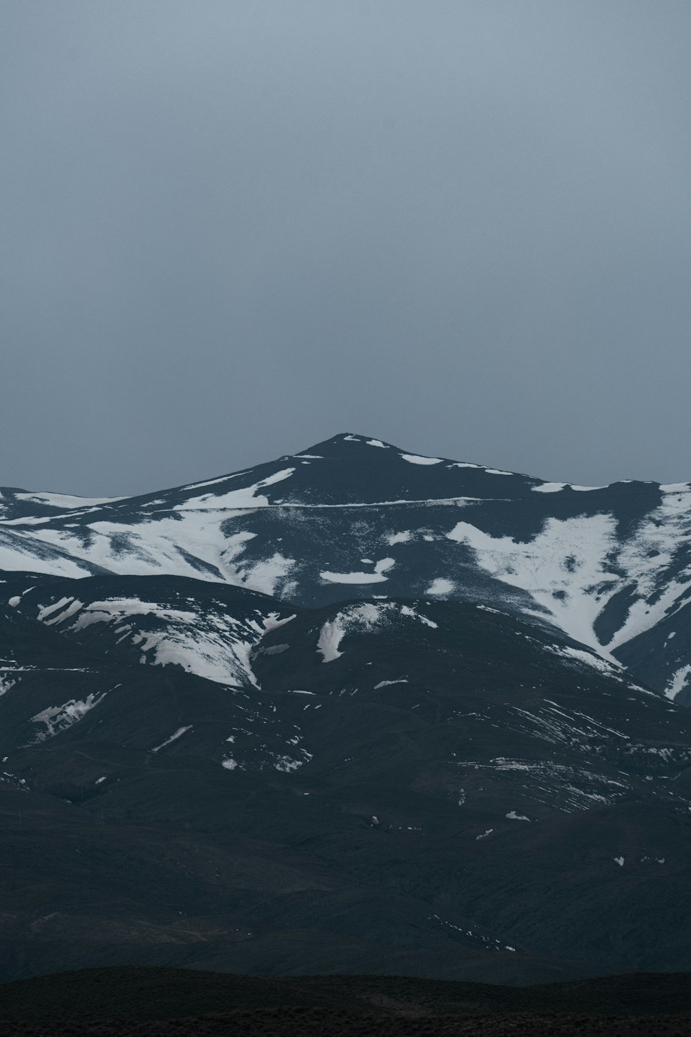 a snow covered mountain range in the distance