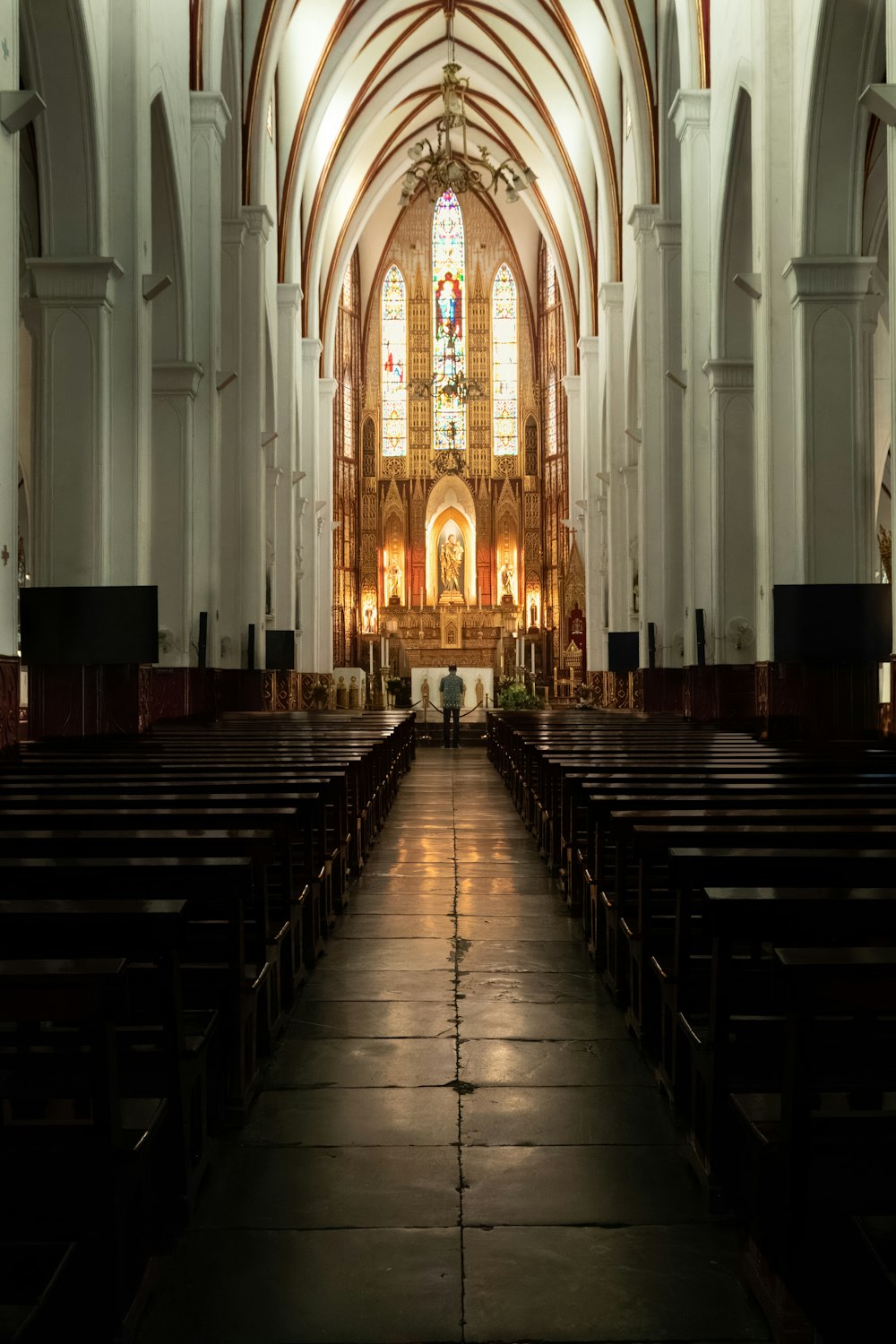 a church with pews and stained glass windows