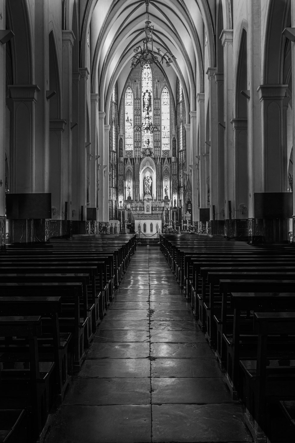 a black and white photo of a church with pews