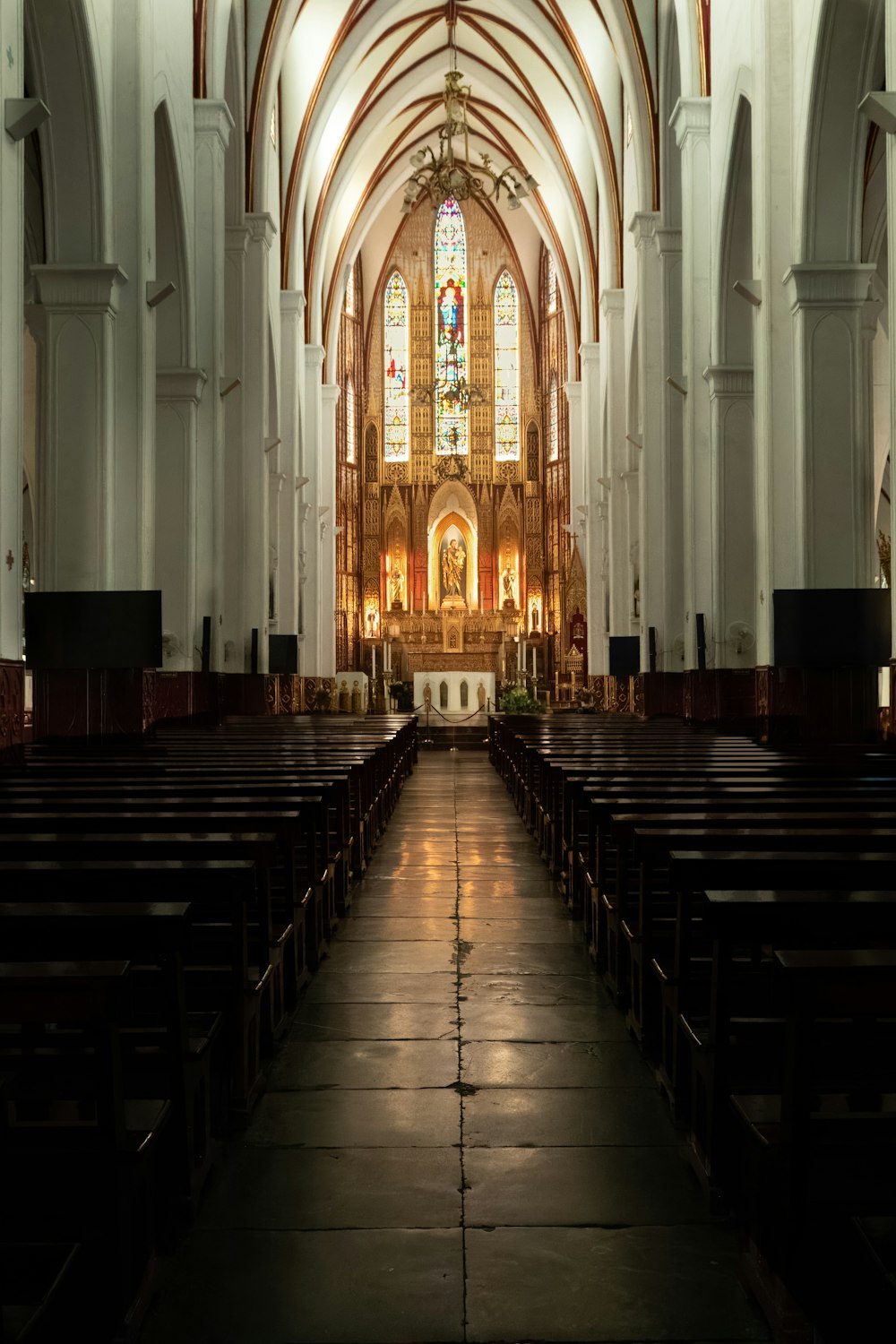 a church with pews and stained glass windows