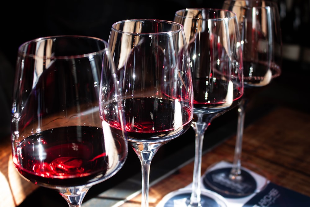 a row of wine glasses sitting on top of a table