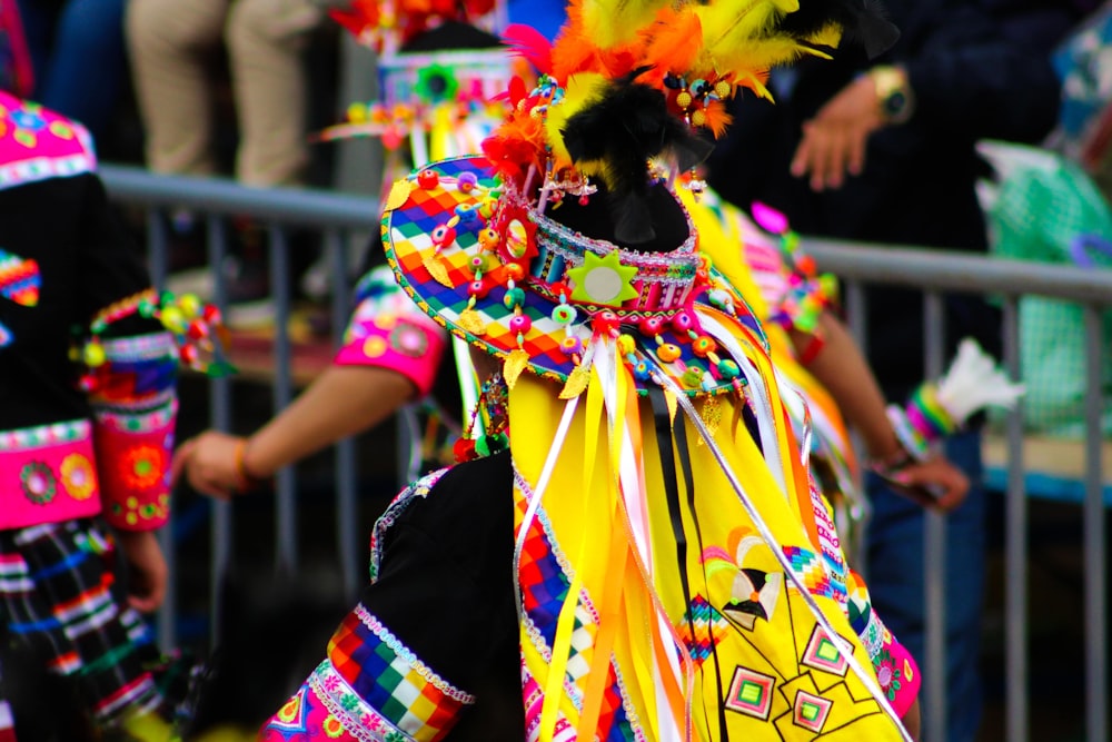 a man in a colorful costume walking down a street