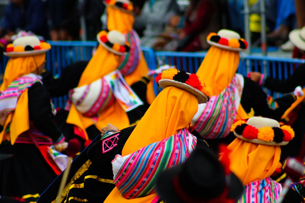 a group of people wearing colorful hats and scarves