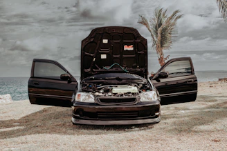 a couple of cars parked next to each other on a beach