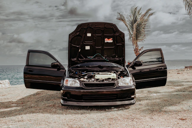 a couple of cars parked next to each other on a beach