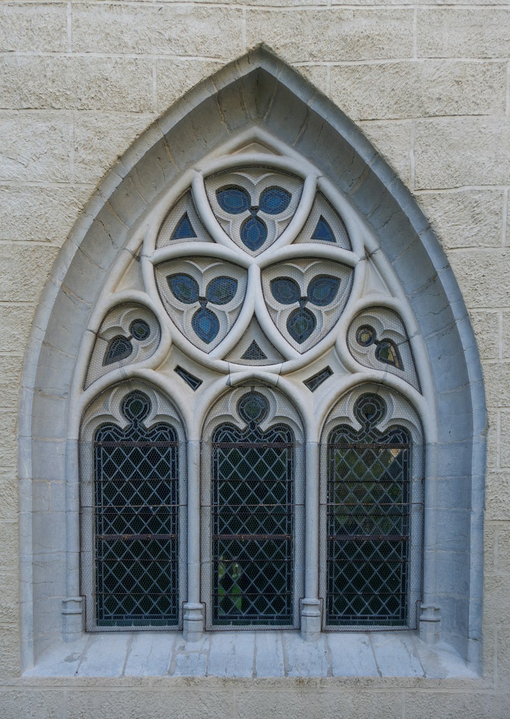 a window in a stone building with a decorative design